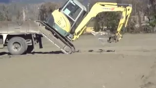 Loading an excavator onto a truck without ramps