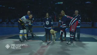 Duke the dog drops the puck at the Winnipeg Jets game