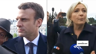 Le Pen and Macron trade barbs amid May Day clashes