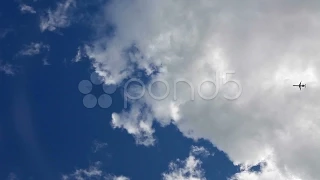 Aircraft Silhouette Flying In The Blue Cloudy Sky. Stock Footage