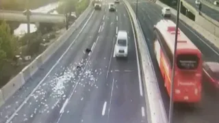 Money showers onto a highway in Chile following a robbery