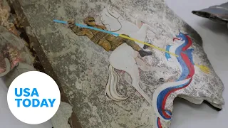 Ukrainian artists paint on Russian missile fragments to raise funds | USA TODAY