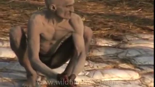Naga sadhu cleans his ash covered body - Ardh Kumbh at Prayaga, 2007