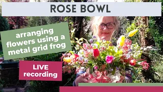 Arranging flowers in a rose bowl using a metal grid flower frog