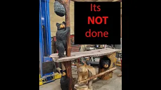 chainsaw carving a bar covered in bears