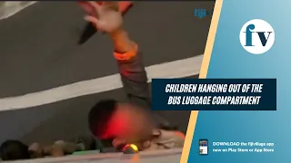Children hanging out of the bus luggage compartment