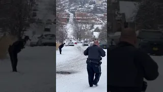 Police car slides down icy road, crashes into parked vehicles