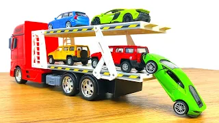 Big die cast model cars being carried by transportation vehicles
