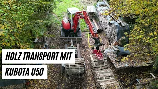 Brennholz Transport vom Holzplatz zum Lagerplatz mit Kubota Bagger und Rückewagen