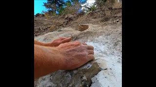 Cracking open a rock to find the Gemstone inside.