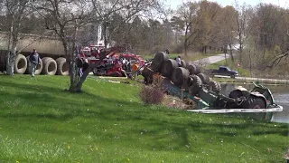 Tractor hauling manure spreader crashes into pond near Saranac