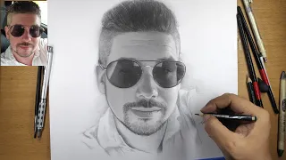 Portrait of a man in glasses with a graphite pencil