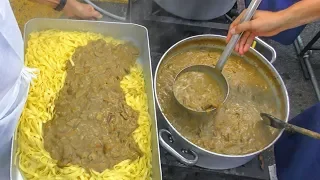 Cooking Huge Pans of Pasta with Mushrooms for Thousands of People. Italy Street Food Festival