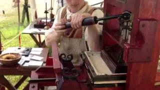 Demonstrating the colonial printing press at the Fair at New Boston in Springfield, OH.