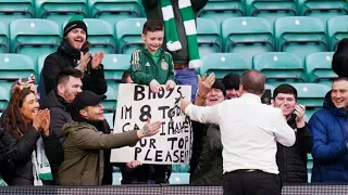 Celtic manager Ange Postecoglou gifts his jumper to a fan after his side's win