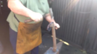 Blacksmith finín Liam Christie forging a shovel