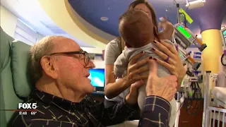 82-year old man cuddles NICU babies