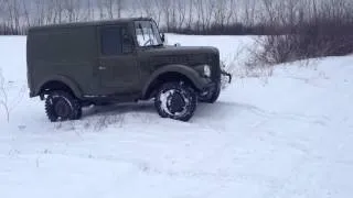 Russian old time car GAZ-69 way through the snow
