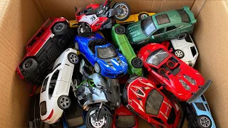 Box full of diecast CARS, Ferrari, Urus, Lamborghini, Motorcycle, Mercedes Benz.
