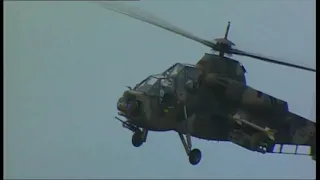 South African Rooivalk Attack Helicopter performing a loop and barrel roll at Airshow.