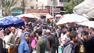 Palestinians in Deir al-Balah shop ahead of Eid amid war