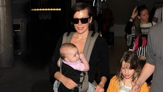 Milla Jovovich Cradles Baby Daughter Dashiel At LAX