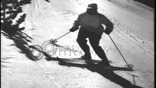 Men sliding downhill and demonstrating the traversing position in the United Stat...HD Stock Footage