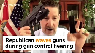 Republican waves guns during U.S. gun-control hearing