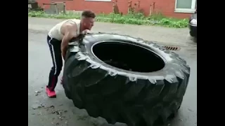 Man Demonstrates Intense Tire Flipping Workout Routine