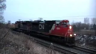 A pair of Howling SD70M-2's CN 8814 & 8832 pass under the bridge @ lovekin on dec30,2010