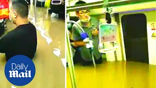 China floods: Shocking moment flooding Chinese subway train traps people up to their necks