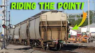 Conductor rides "The Point" of a loaded grain train off the main-line as a local train waits to move