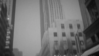 1950's New York City - Tilt down skyscraper to cars on street archival footage