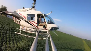 What it looks like crop dusting with a helicopter  - spray boom perspective