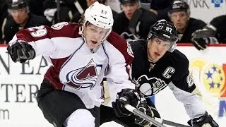 Pittsburgh Penguins' Sidney Crosby dekes out Colorado Avalanche's Nathan MacKinnon