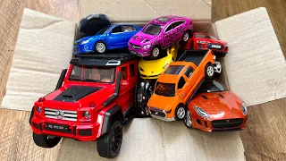 Box full of various miniature cars Jaguar, Peugeot, Renault, Hyundai, Mazda, Volvo, Honda, Opel #004