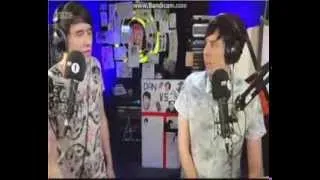 Dan looking sad, Phil looking worried