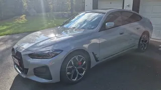 BMW i4 brooklyn grey metallic with summer sun