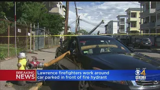 Firefighters Run Hose Through Car Blocking Hydrant At Lawrence Fire