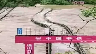 Metal bridge washed away by raging floodwater in NW China