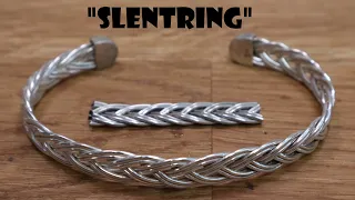 Fingerloop braiding a silver bracelet.
