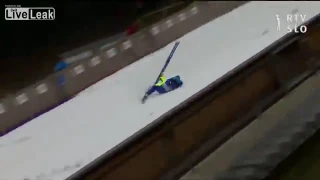 Ski jumper face plants on jump platform