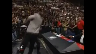 The Undertaker chokeslams Gerald Brisco through Announce table