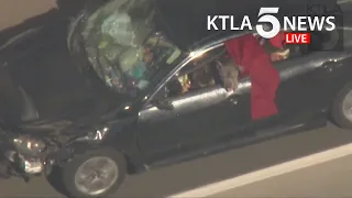 Driver in custody after leading pursuit with pit bull hanging out window in San Fernando Valley