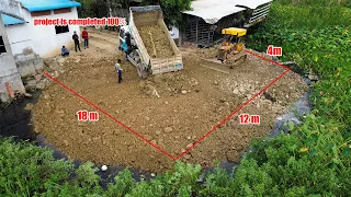 The project is completely 100% by Bulldozer Komatsu Pushing Soil Stone into Canal fill the Land