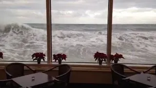 Waves crash against the Marine Room