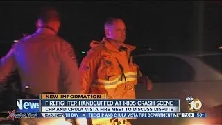 Firefighter handcuffed at scene of crash