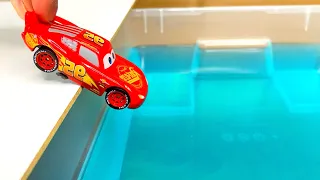 A Lots Of Small Diecast Cars Sliding Into The Blue Water