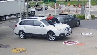 VIDEO: Woman fights off would-be carjacker by jumping on hood