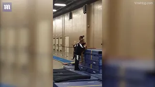 Coach shows off reflexes to save gymnast from dangerous fall